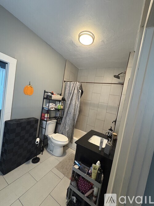 A bathroom with a black vanity and a shower.