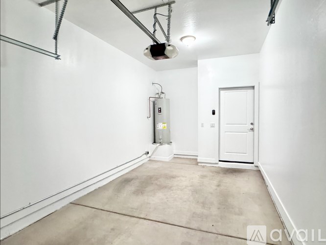 A room with a white door and a white wall with a vent.