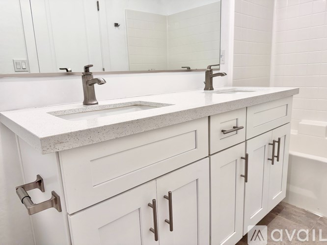 A bathroom with a sink and a mirror.