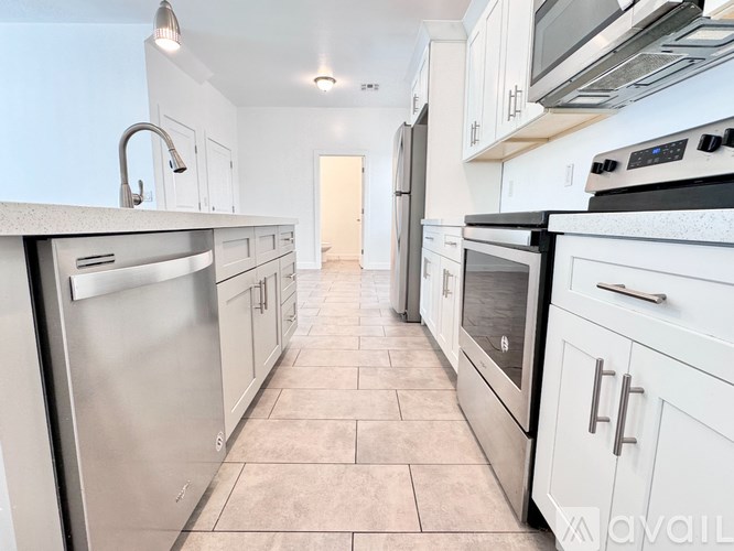A room with a carpeted floor and a door.