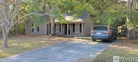 A house with a car parked in front of it.