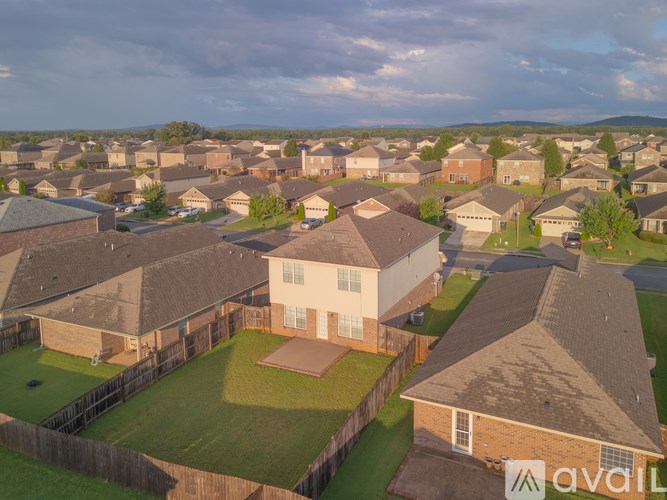 A neighborhood with houses and a cloudy sky.