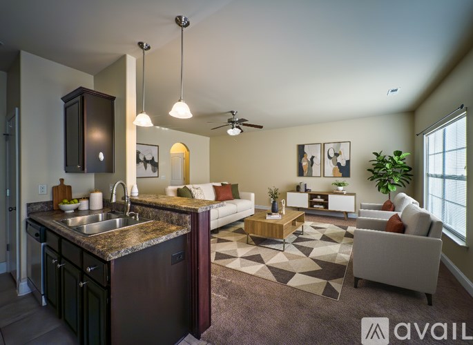 A kitchen with a sink and a counter with a brown and green color scheme.