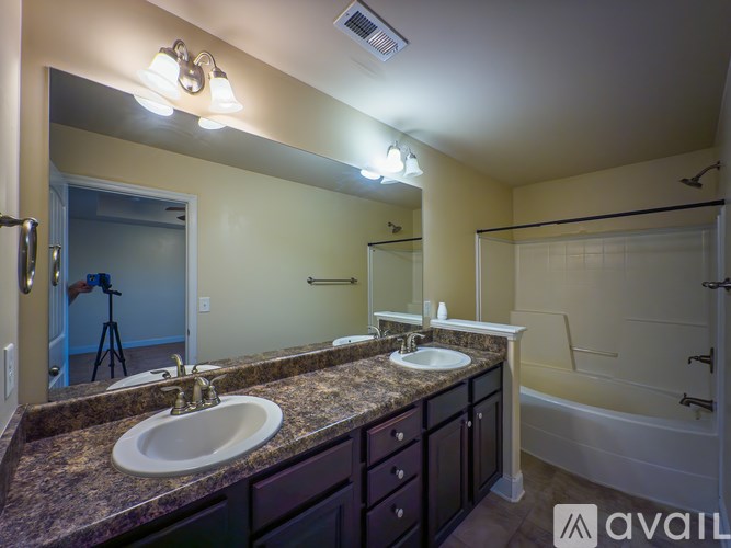 A bathroom with two sinks and a bathtub.