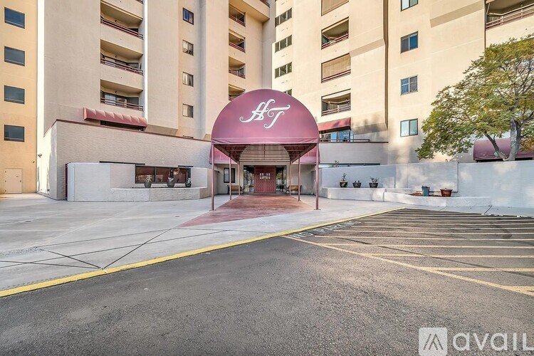 A hotel with a red awning and the letter H on it.