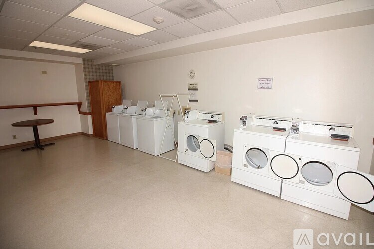 A laundry room with washers and dryers.