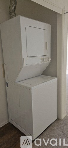 A white microwave oven with a drawer is installed in a kitchen.
