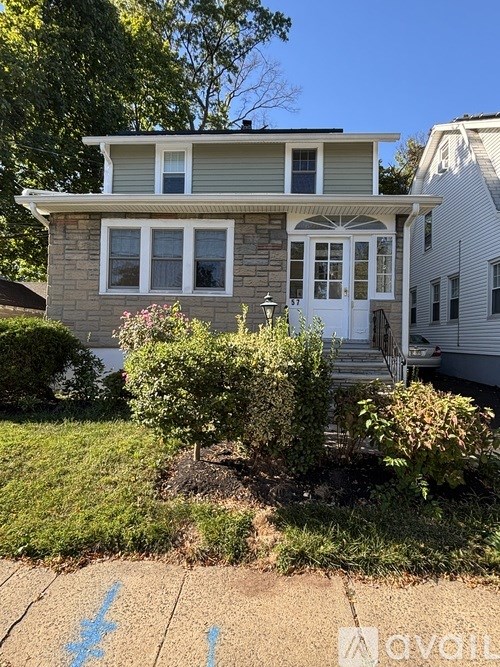 A two-story house with a white door and windows.