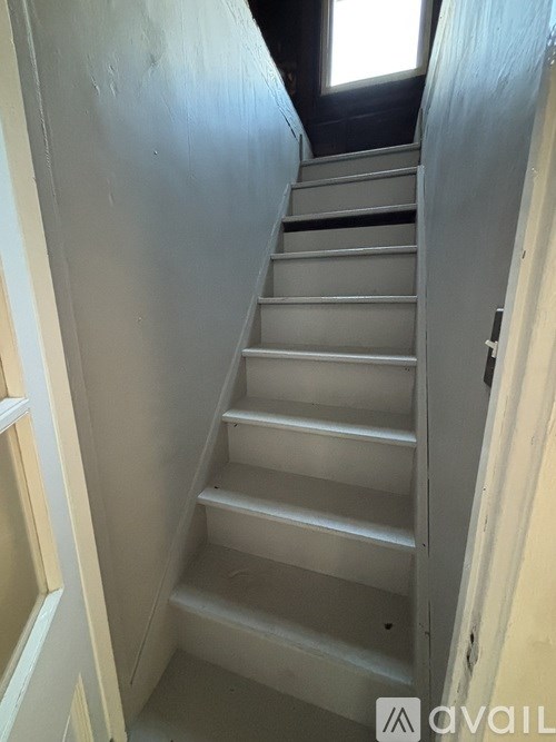 A staircase with a metal railing and steps leading upwards.