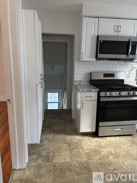A kitchen with a stove top oven and microwave above it.