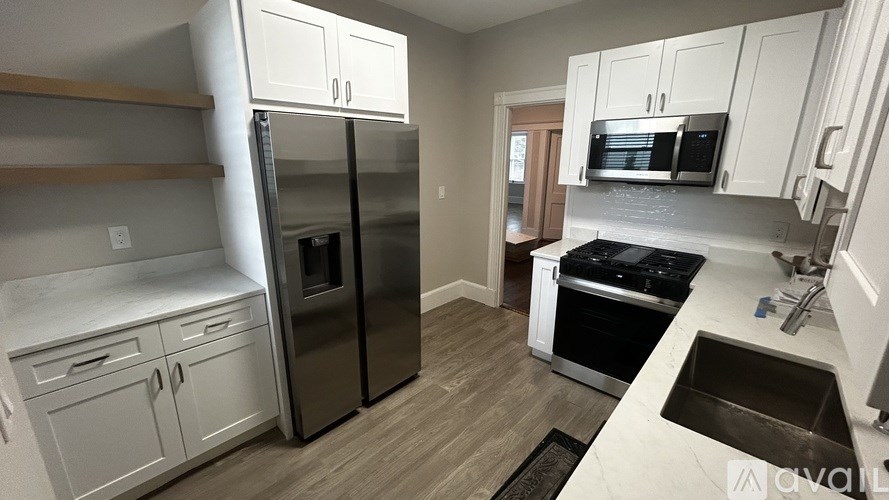 A kitchen with a stainless steel refrigerator and oven.