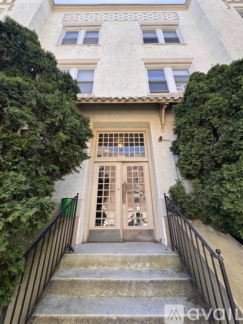 A house with a staircase leading to a door.