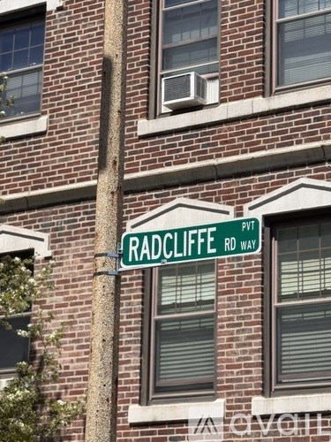 A sign on a pole that says Radcliffe Rd Way.