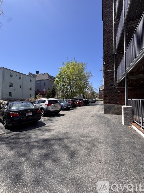 Cars parked in a parking lot next to a building.
