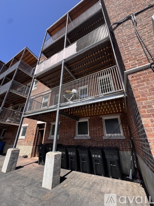A multi-story building with a balcony on the second floor.