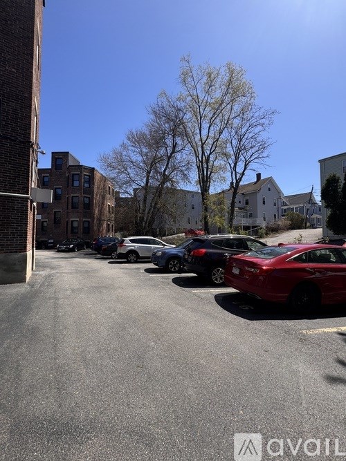 A parking lot with cars and buildings in the background.