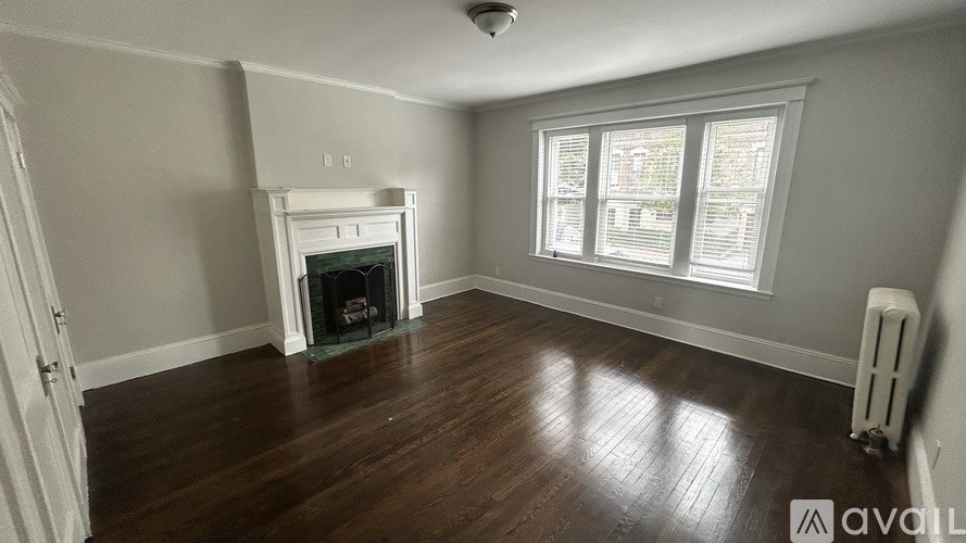 A room with a fireplace and a window.
