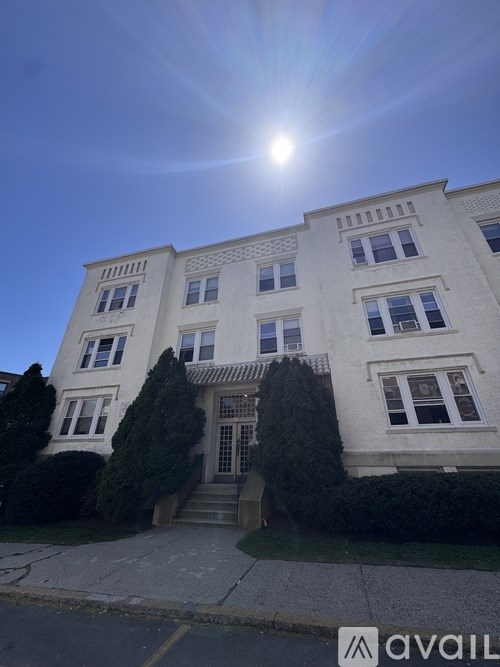 A sunny day with a building in the background.