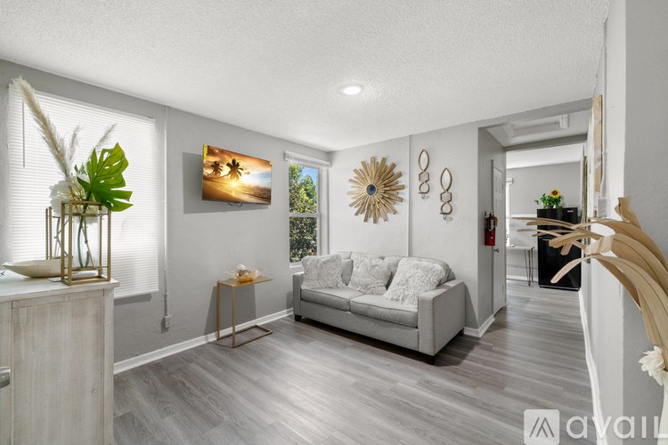 A living room with a grey sofa and a wooden side table.