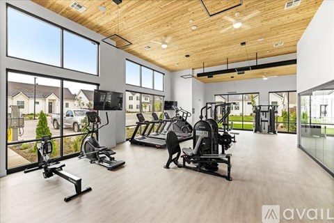 A gym with a variety of equipment including treadmills, stationary bikes, and weight machines.