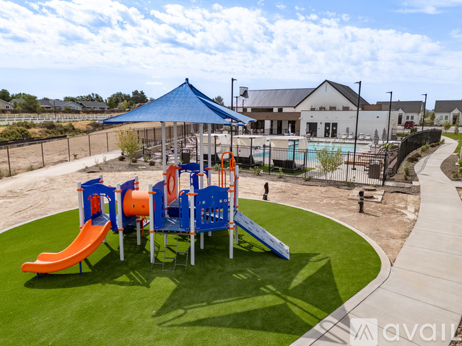 A playground with a blue canopy and orange and blue slides.
