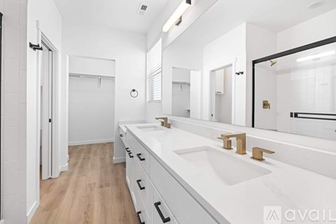 A bathroom with a white sink and a mirror.