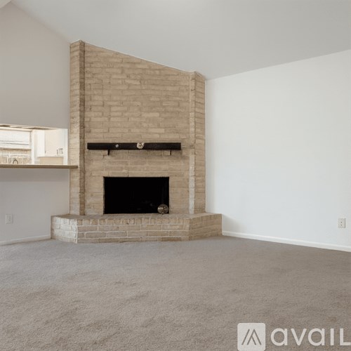 A room with a fireplace and a carpeted floor.