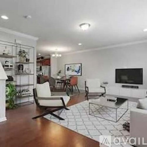A living room with a white couch and a television.