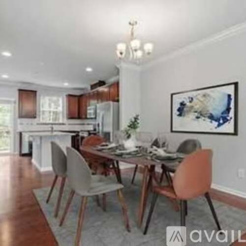 A dining room with a wooden table and chairs.