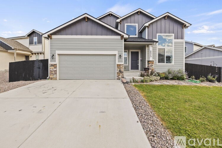 A house with a grey garage door is for sale.