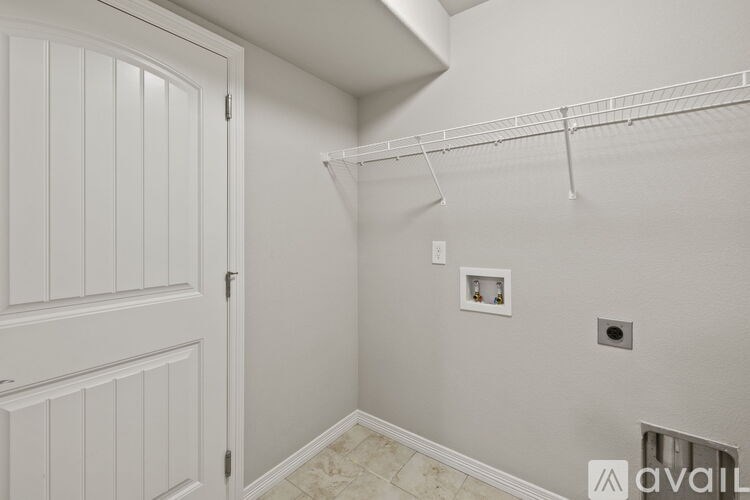 A white door with a small picture on the wall above it.