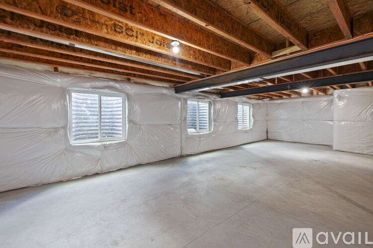 A room with wooden beams and insulation on the walls.