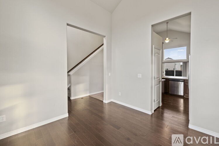 A room with a white wall and a wooden floor.
