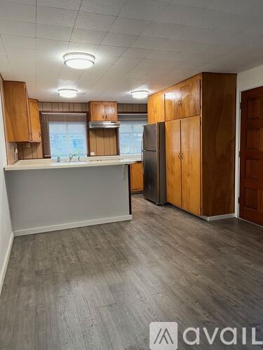 A kitchen with wooden cabinets and a white countertop.