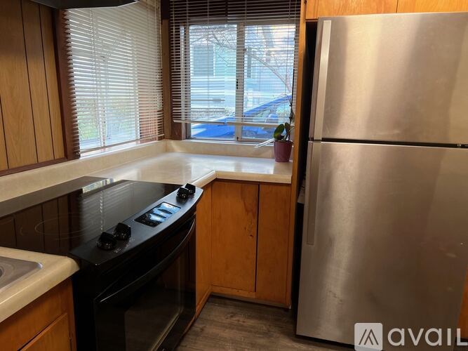 A kitchen with a stove top oven and a refrigerator.