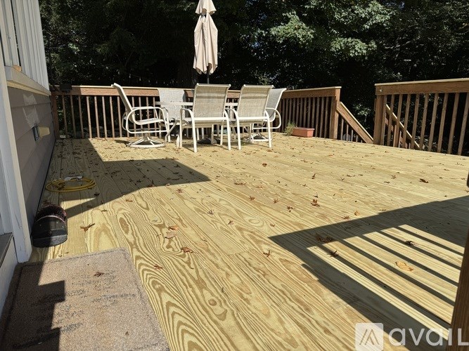 A wooden deck with a table and chairs.
