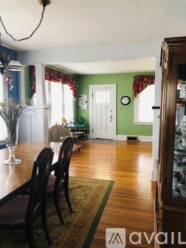 A dining room with a table set for four.