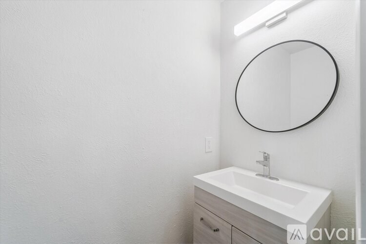 A bathroom with a white sink, toilet, and bathtub.