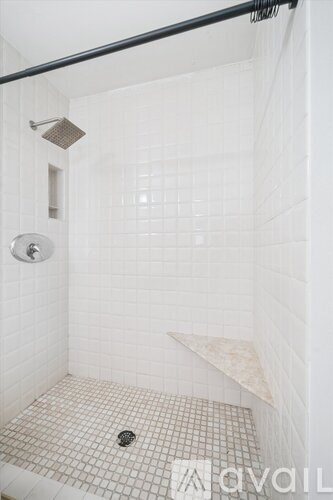 A staircase with a metal railing and steps leading to a white door.