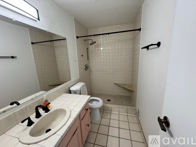 A bathroom with a sink, toilet, and shower.
