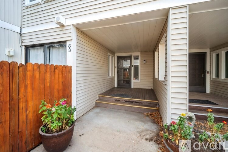 A room with wooden flooring and white walls.