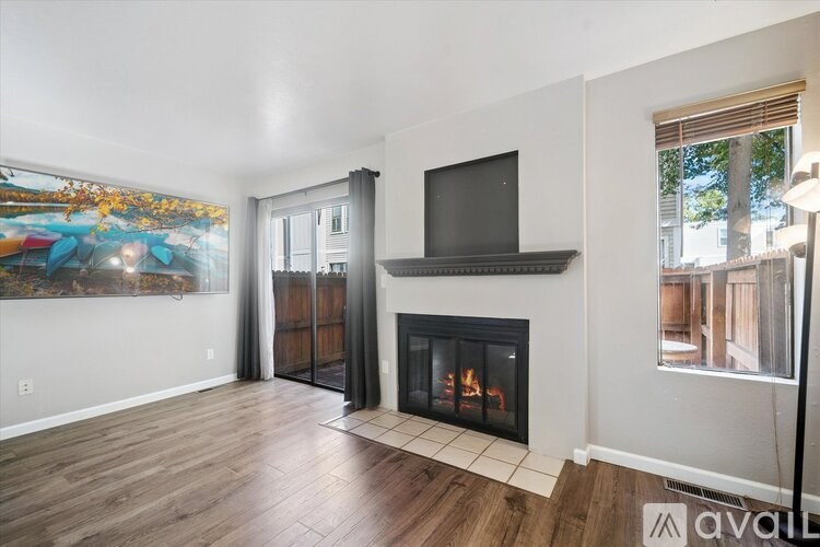 A laundry room with two washing machines and a tub of water.
