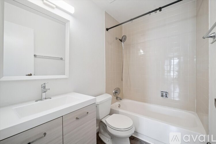 A white bathroom with a toilet, sink, and bathtub.