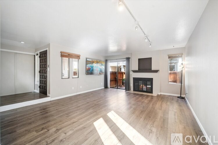 A small table and two chairs are set up on a snow-covered patio.