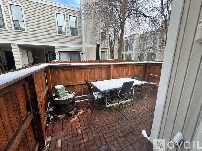 A small table and chairs are set up on a patio.