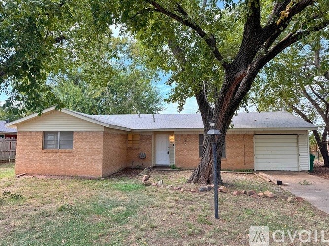 A house with a tree in front of it.