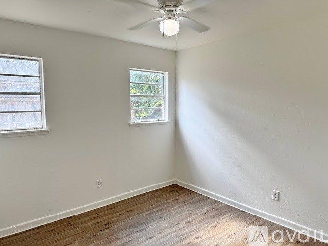 A room with a ceiling fan and a window.