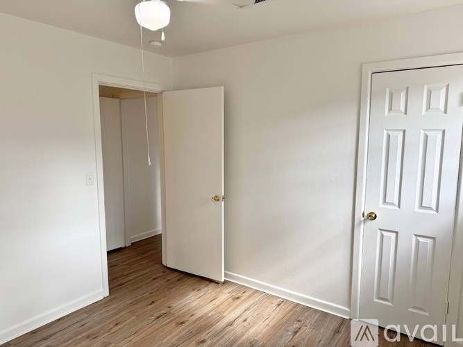 A room with a white door and a white wall.