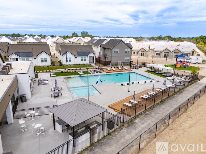 A pool area with a black fence and a gazebo.