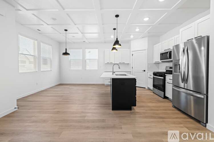A kitchen with white cabinets and stainless steel appliances.